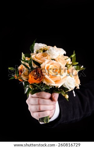 Artificial Flowers Bouquet in Hand Isolated on Black Background