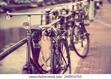 Secured Aged Rusty Bikes in Amsterdam. Netherlands Transportation. Vintage Color Grading.