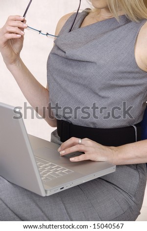 Business woman with Laptop and glasses in sitting position.