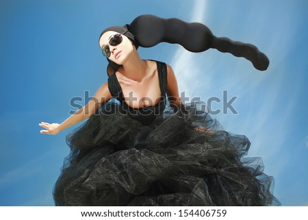 girl with black head-dress under the blue sky