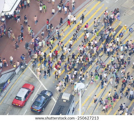 Hong Kong, China - October 19, 2013:  Commuters in a busy crosswalk in Causeway Bay, Hong Kong. Causeway Bay is a major shopping district and one of the most crowded areas in Hong Kong.