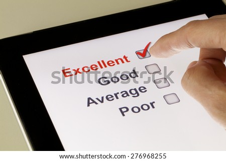 Completing online survey on a tablet, clicking excellent