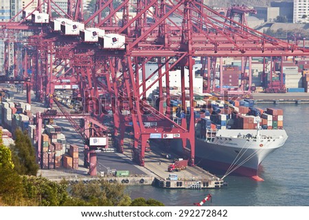 Hong Kong, China - February 6, 2011: Cargo ship loading at the Kwai Tsing Container Terminals in Hong Kong. The terminal is one of the largest and busiest ports in the world.