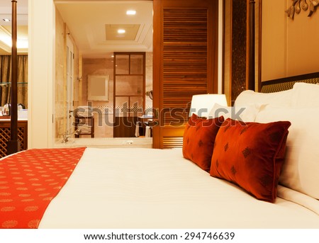 View of a luxury hotel room with king bed and ensuite