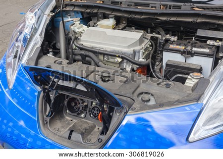 Charge port and motor unit under the hood of an electric car