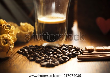 Bunch of old roses with cinnamon brown sugar coffee beans on old wooden table