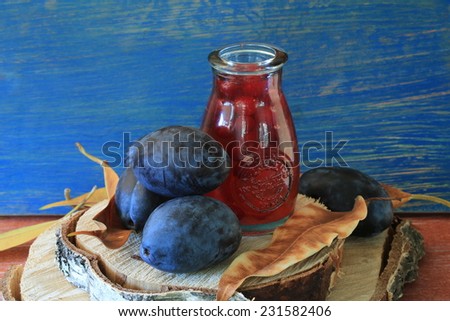 plum fruit compote juice on a wooden table fresh brick wall eco farm products
