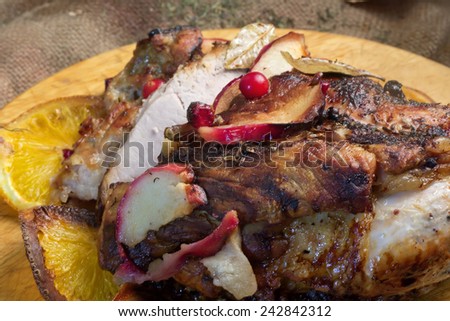 baked meat with apple cranberry orange selective soft focus toned photo