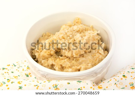 breakfast oatmeal in a white ceramic bowl shabby chic vintage retro selective soft focus
