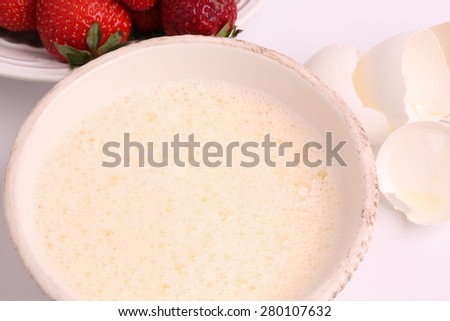 whipped to a froth the eggs in a bowl on a white background selective soft focus