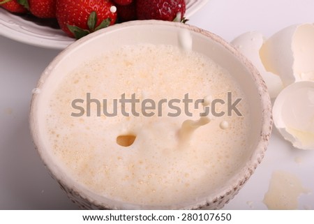 whipped to a froth the eggs in a bowl on a white background selective soft focus