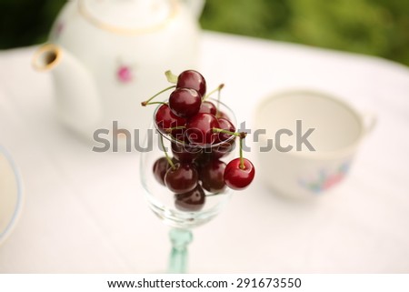 cherry tea cup glass table in a garden courtyard for summer tablecloth selective soft focus