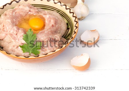 Chicken ground meat for meatballs onion garlic eggs wood background texture old retro vintage home cooking