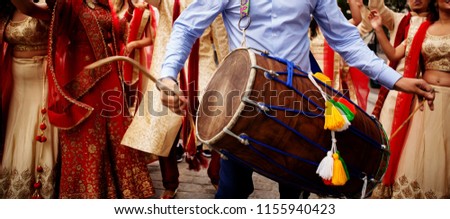 Man playing drum (Dhol) on wedding of his friend.