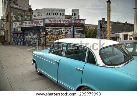 Williamsburg-Brooklyn, New York, USA- July 12, 2015: classic car next to an old garage in Williamsburg north side. July 12, 2015 in Williamsburg, New York.