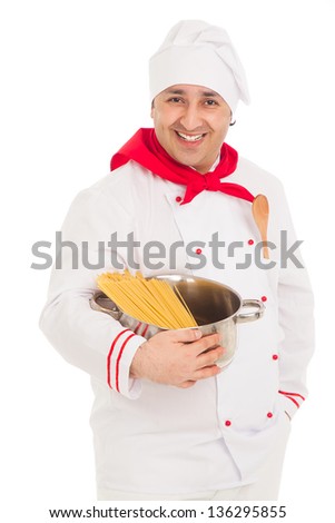 smiling cook man holding pan filled with raw macaroni wearing white uniform in the studio over white background