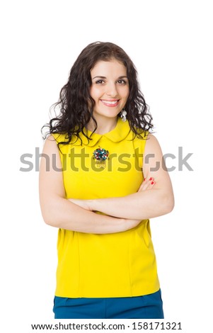 beautiful brunette happy girl with curly hair wearing yellow blouse and blue pants over white background