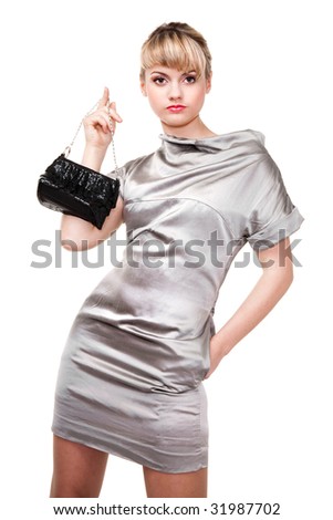 beautiful model in silver dress holding black purse