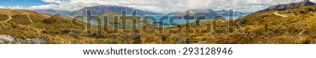 Panoramic view of Queenstown from top of Queenstown Hill in a cloudy day. We can see The Remarkables mountain and Lake Wakatipu.
