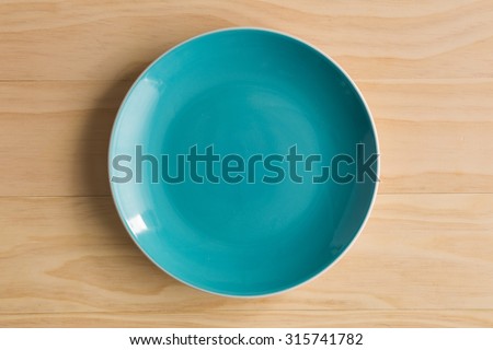 blue plate on wooden background