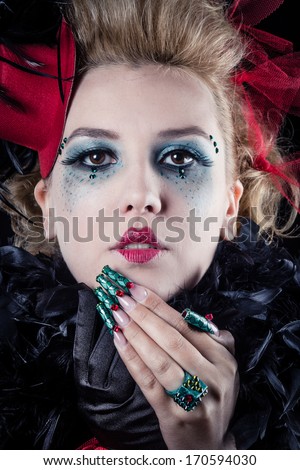 Pretty young ringmaster woman with a red hat and green nails