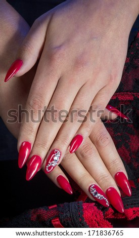 Pretty woman hand with red nails and lingerie