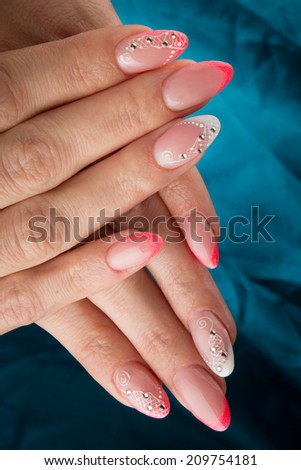 painted nails and hands isolated on blue background