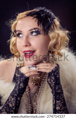 Retro portrait of beautiful happy blonde smiling woman with jewels and extreme long nails. Gatsby, Vintage style. Isolated on black background