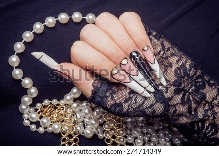 Retro jewels and extreme long nails on black silk. Gatsby, Vintage style