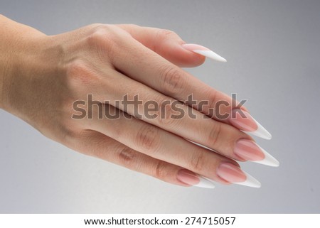 Painted extreme long nails and hands isolated on white background