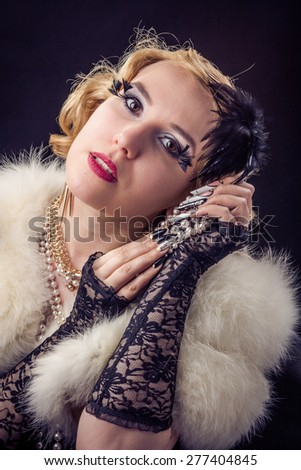 Retro portrait of beautiful blonde woman with jewels and extreme long nails. Gatsby, Vintage style. Isolated on black background