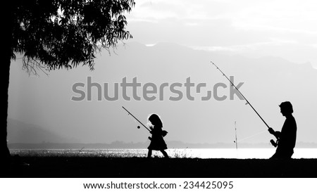 A father fishing with his daughter in the sunset. Photo taken in Port Douglas, Australia