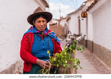 CUSCO, PERU April 07, 2015: A traditionally clothed peruvian woman with a lama