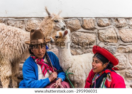 CUSCO, PERU April 01, 2015: Traditonally clothed peruvian women with a lama