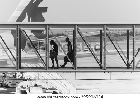 BARCELONA, SPAIN June 30, 2015: people walking through a gateway at barcelona airport