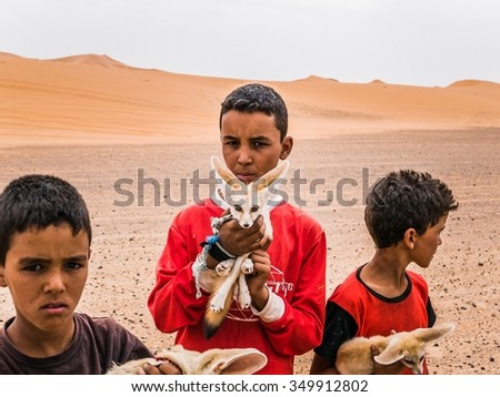 Merzouga, Morocco - Circa September 2015 - young children with desert foxes