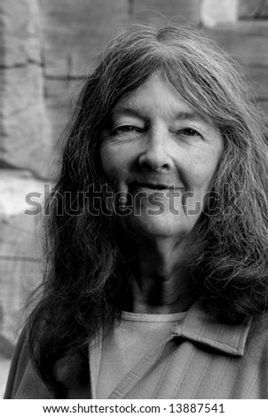 smiling senior lady in black and white with strong side lighting