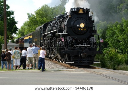 OWOSSO, MI - JULY 25: NKP 765 hauls passengers on a excursion for Train Festival 2009 as it passes a photo line on July 25, 2009 in Owosso, MI. The 765 is owned by the Fort Wayne Historical Society.