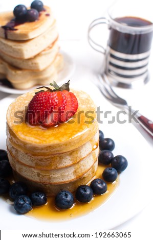 Pancakes with honey, berries and coffee