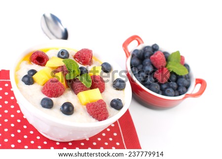 Oat porridge with berries isolated on a white background