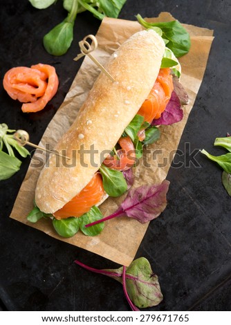 sandwich with red fish and greens