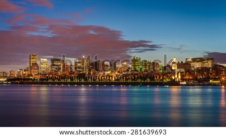 Montreal city skyline over Saint Lawrence River at twilight with urban buildings, Montreal, Quebec, Canada