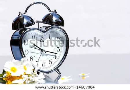 old silver with alarm bells and flowers on neutral background