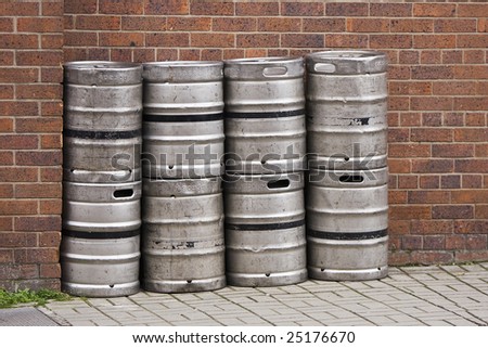 a row of beer kegs outside a pub