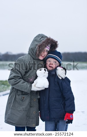 brother and sister hug each other on a cold winters day
