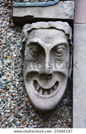 ugly gargoyles head made from carved stone