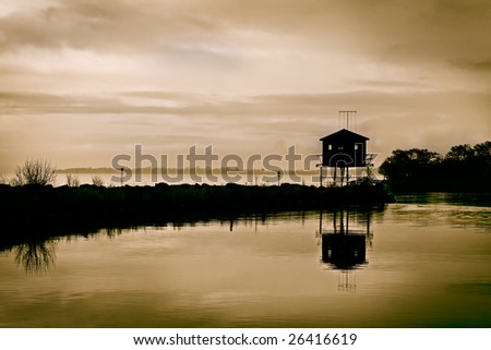 moody skies above a bird watching hide at twilight