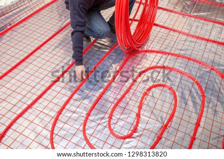 Pipefitter installing system of heating. Heating system and underfloor heating.