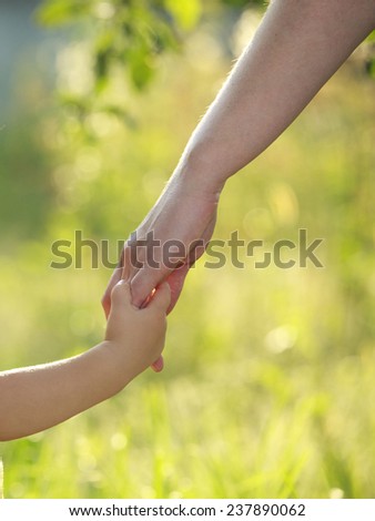 Mother and son holding hand in hand