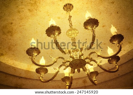 Vintage chandelier hanging under a ceiling in home
